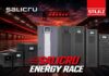 Salicru busca nuevos canales para impulsar soluciones de protección y gestión de energía Composición gráfica que muestra una serie de equipos y sistemas de respaldo de energía alineados sobre una pista de carreras bajo un cielo rojizo al atardecer. En la imagen destacan los logotipos de Salicru y Stulz, acompañados del texto promocional "SALICRU ENERGY RACE" en la parte inferior.