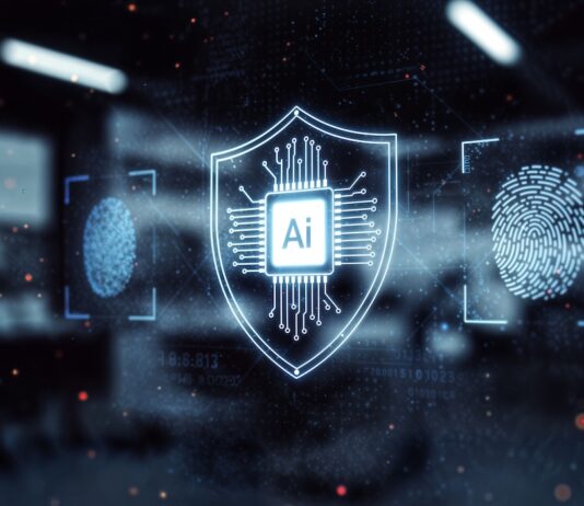 Sophos y OpenAI llevan la IA avanzada al canal para reforzar la ciberseguridad Ilustración digital de un escudo holográfico luminoso con un microchip y las letras "Ai" en el centro, flanqueado por íconos de escaneo de huellas dactilares y flujos de datos sobre un fondo oscuro de aspecto tecnológico.