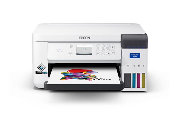 Epson exhibe la impresora SureColor F170 para sublimación y personalización de productos en FICTI 2026 Fotografía en render de producto de vista frontal de la impresora de escritorio Epson SureColor F170 con tanques de tinta visibles, mostrando la salida de un diseño a color impreso en papel de sublimación.